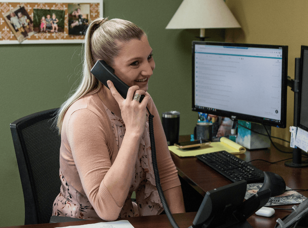 woman smiling on phone in office